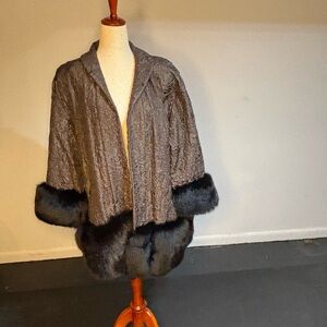 Elegant brown jacket and skirt. Fur trimmed hem and cuffs on jacket.